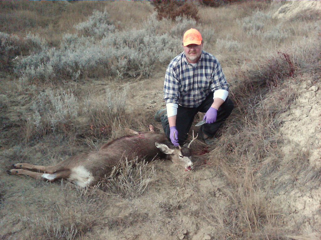 Jim Taylor with a deer harvest, hunter safety concept. 
