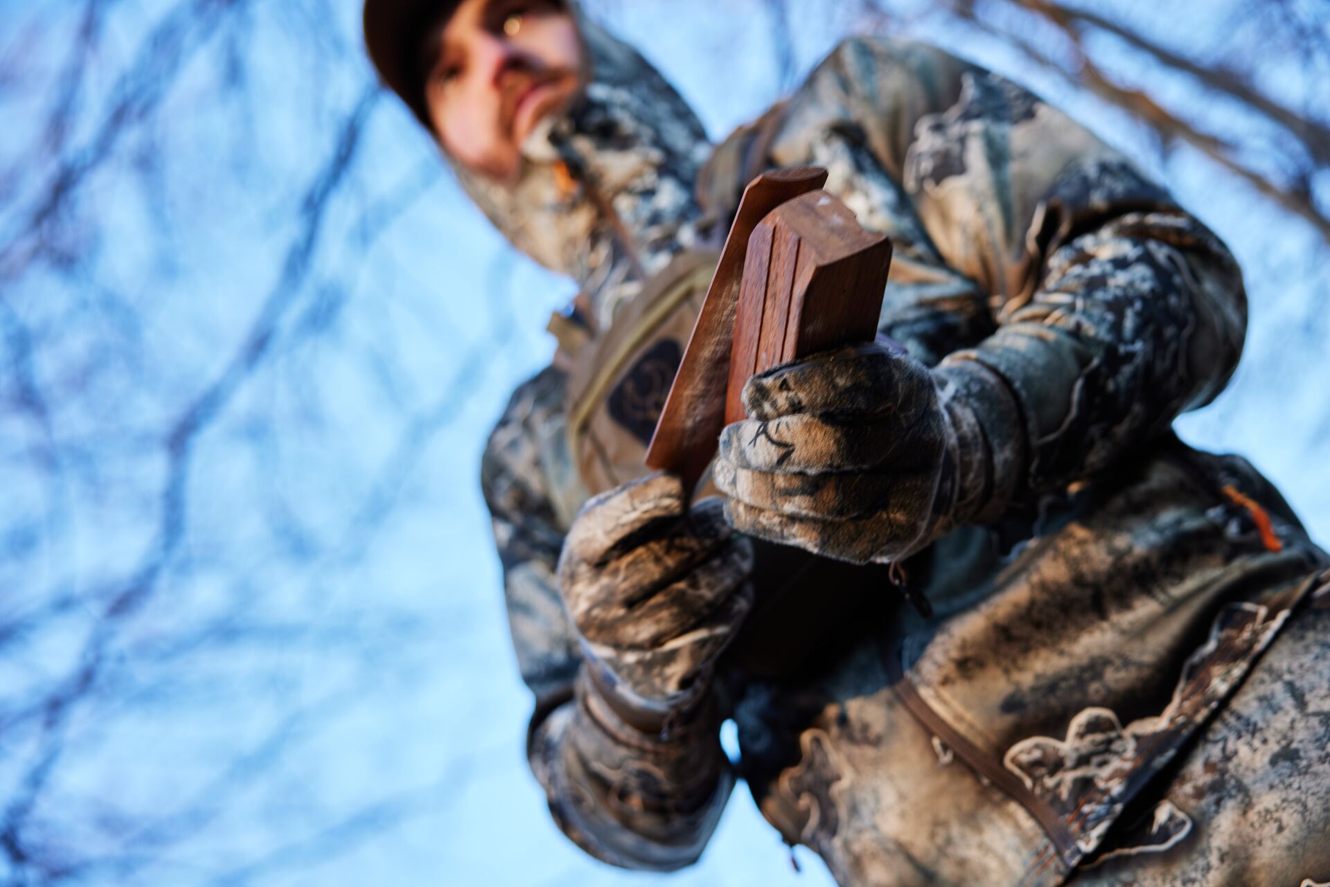 Hunter using a turkey box call, types of turkey calls concept. 