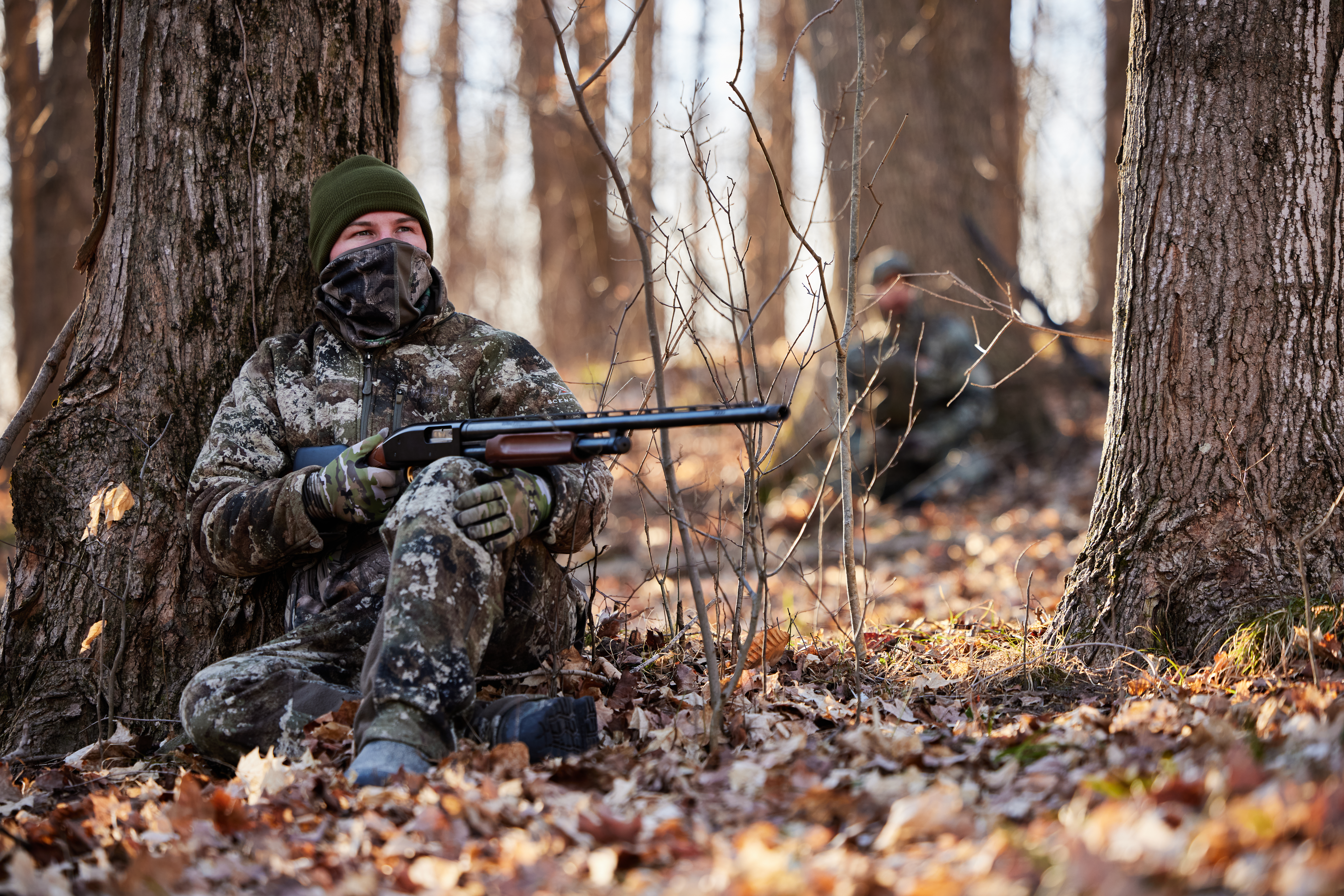 Hunters waiting for turkeys in the woods, turkey hunting concept.
