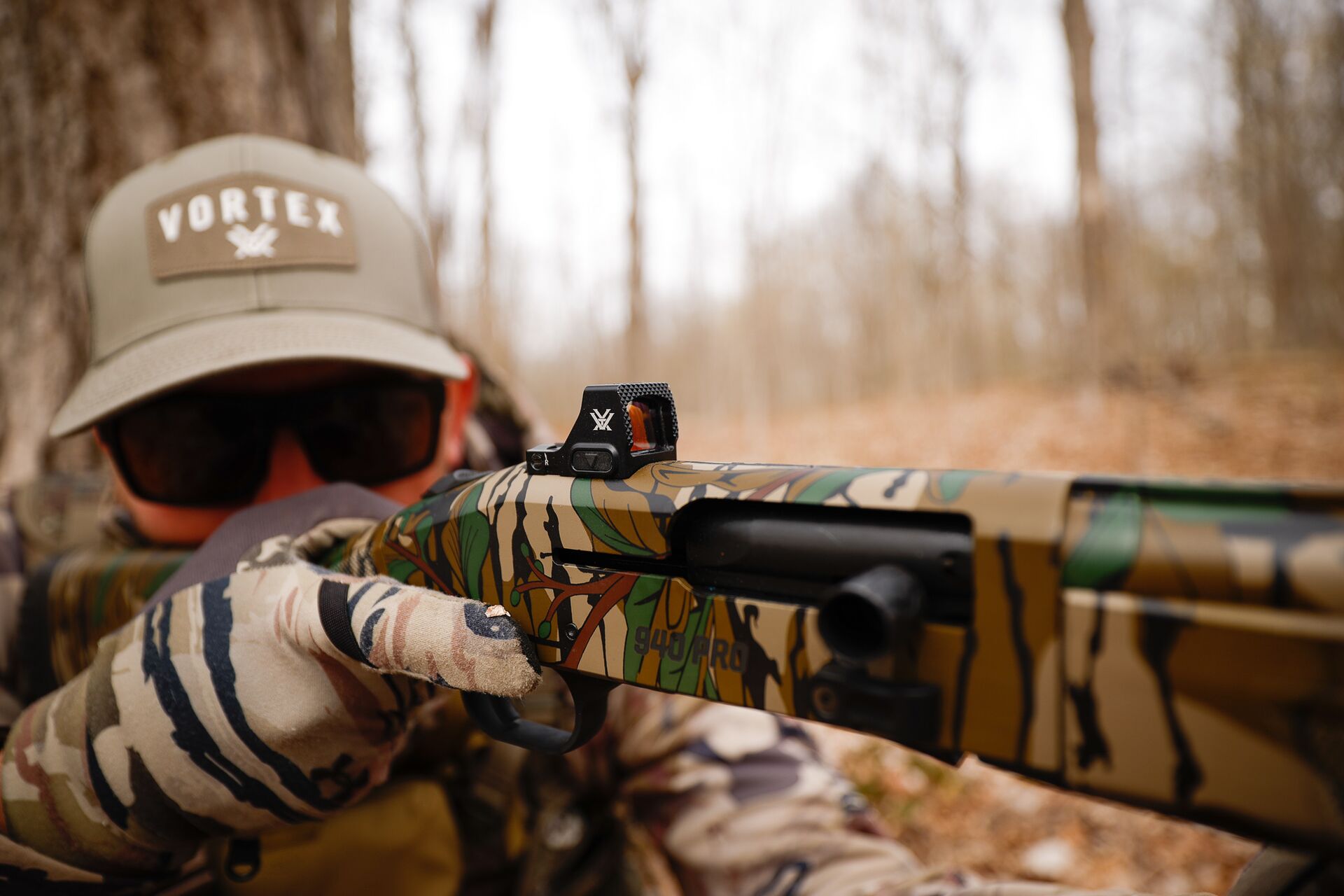 A hunter in camo aims a shotgun, shotgun patterning concept.