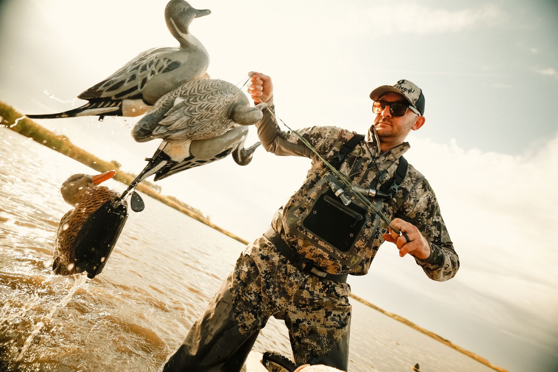 Hunter in the water with waterfowl decoys. 