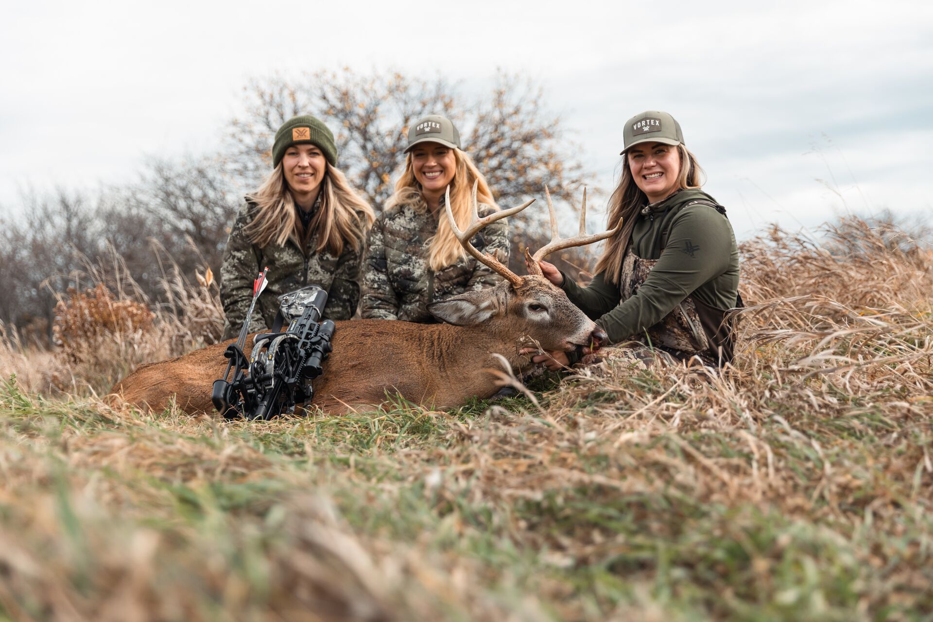 Three women with a deer after a hunt, how to get a hunting license in Oklahoma concept.