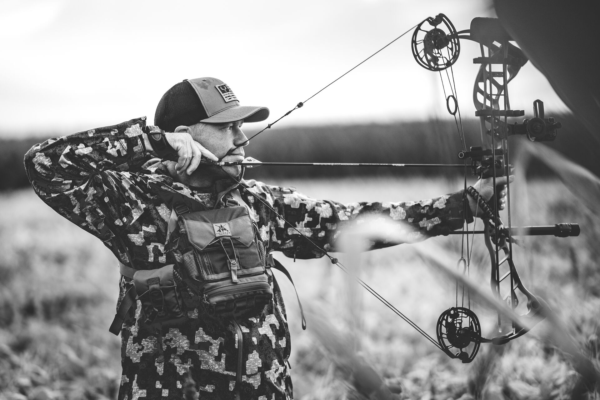 A bowhunter draws a bow, take a bowhunter safety course concept. 