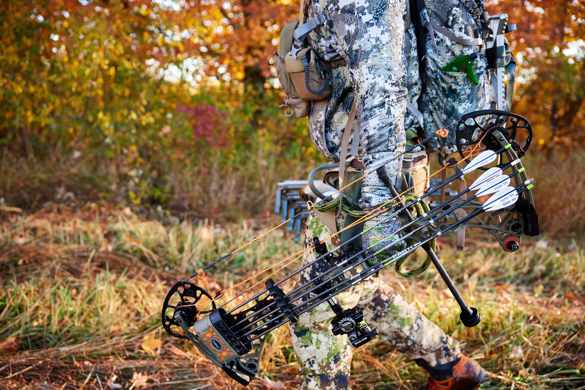 Hunter carries a compound bow for a hunt. 