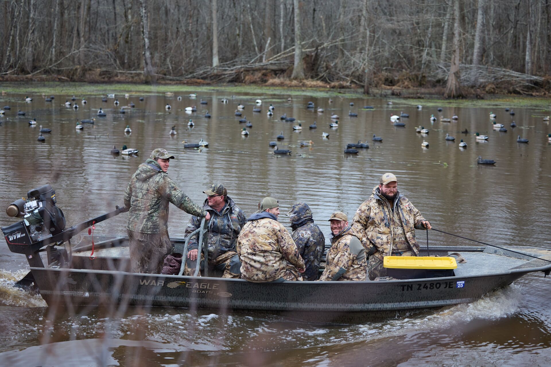Waterfowl hunters in a boat on the water. 