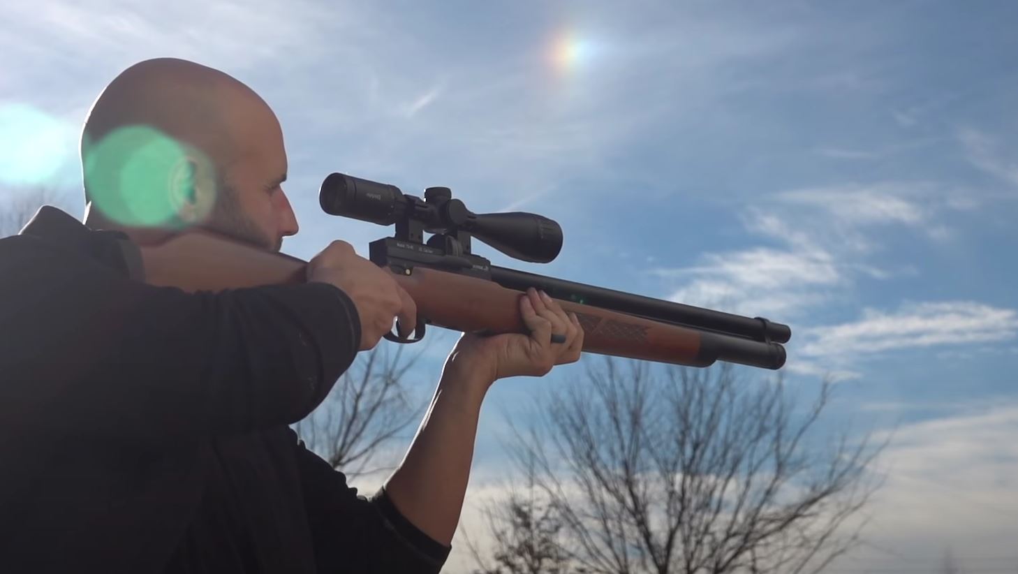 Hunter aiming big bore air gun, big game hunting with air rifle concept. 