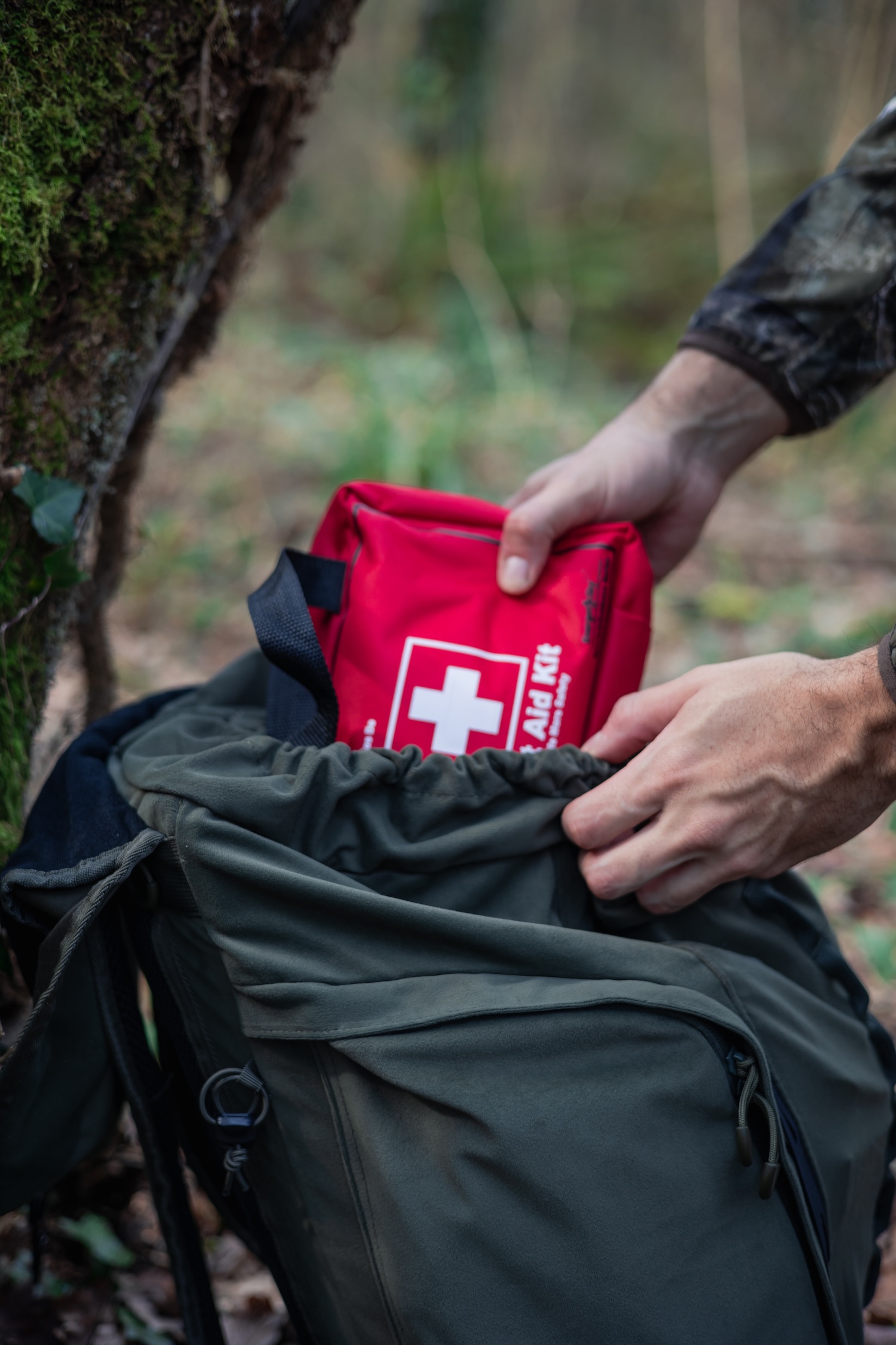 Putting a first aid kit into a hunting backpack. 
