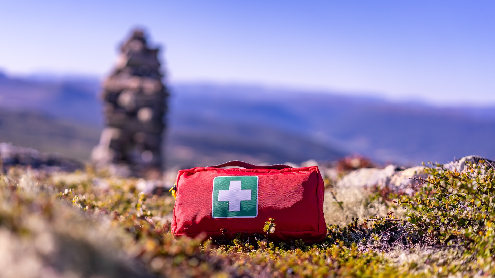 A first aid kit on the ground, hunting emergency kit concept. 