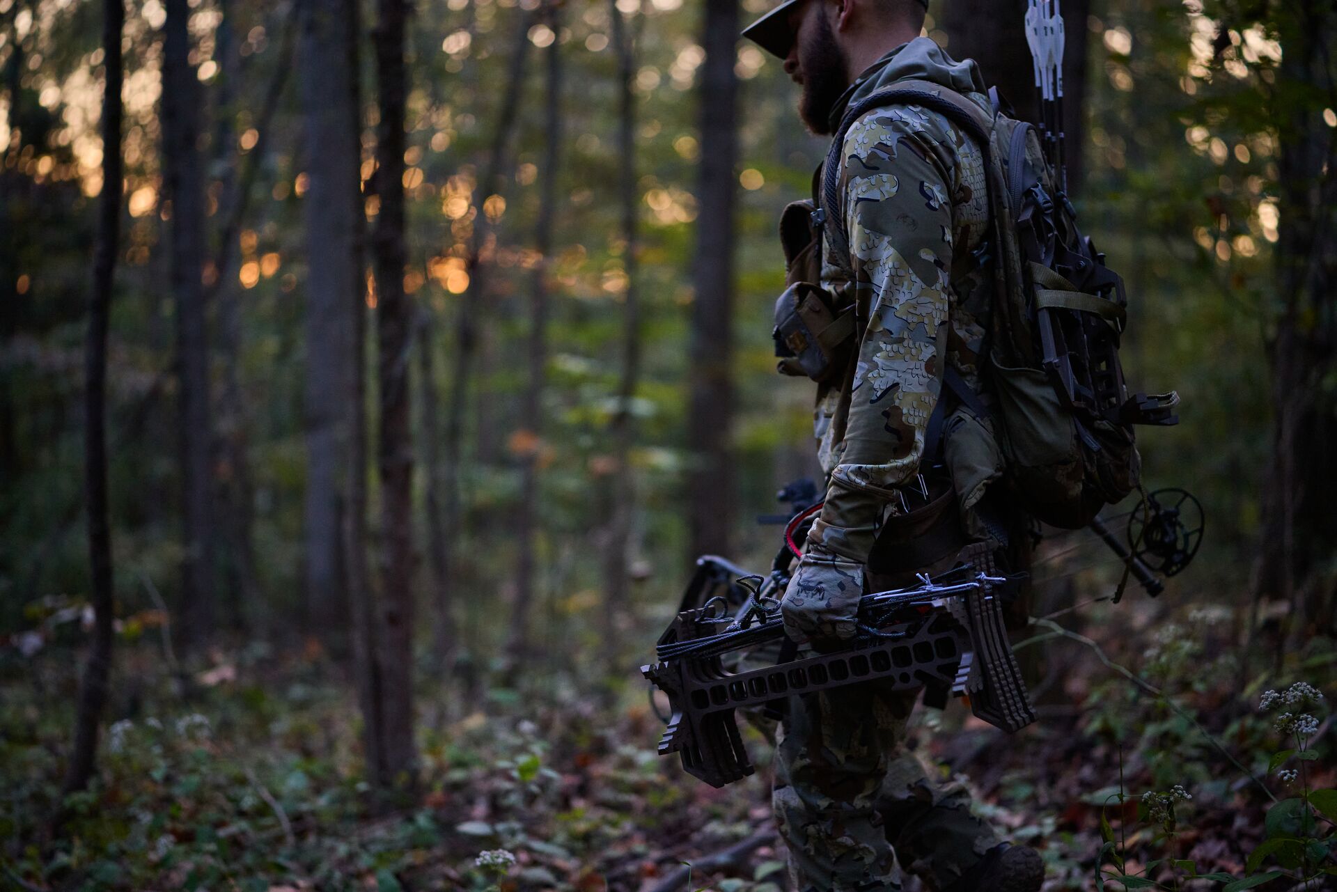 Hunter carries gear in the woods. 