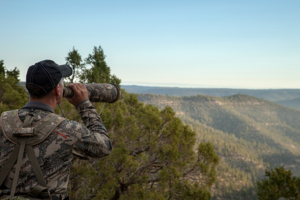 A hunter using an elk call during elk hunting. 