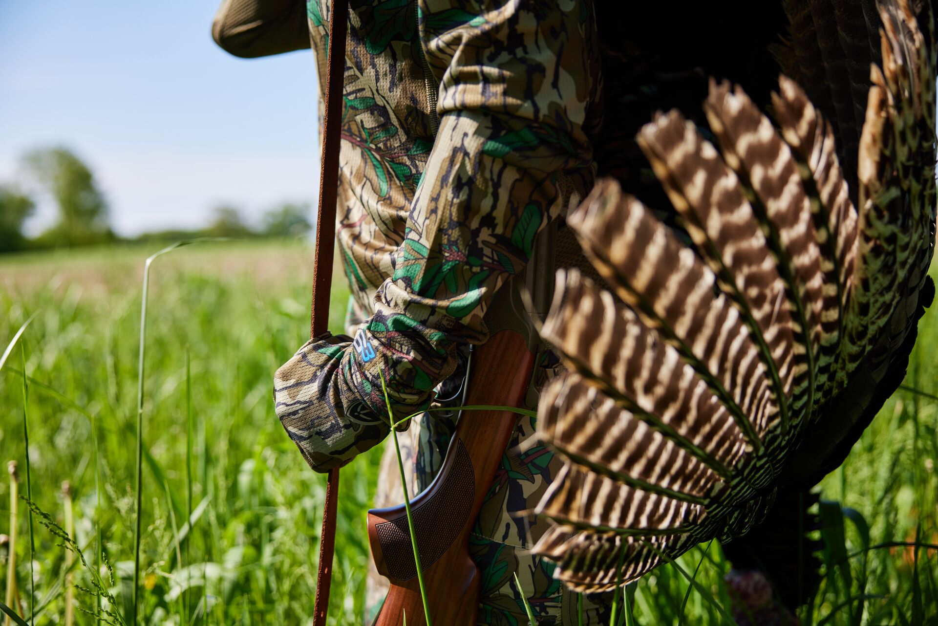 Close-up of hunter holding turkey on their back after hunt. 