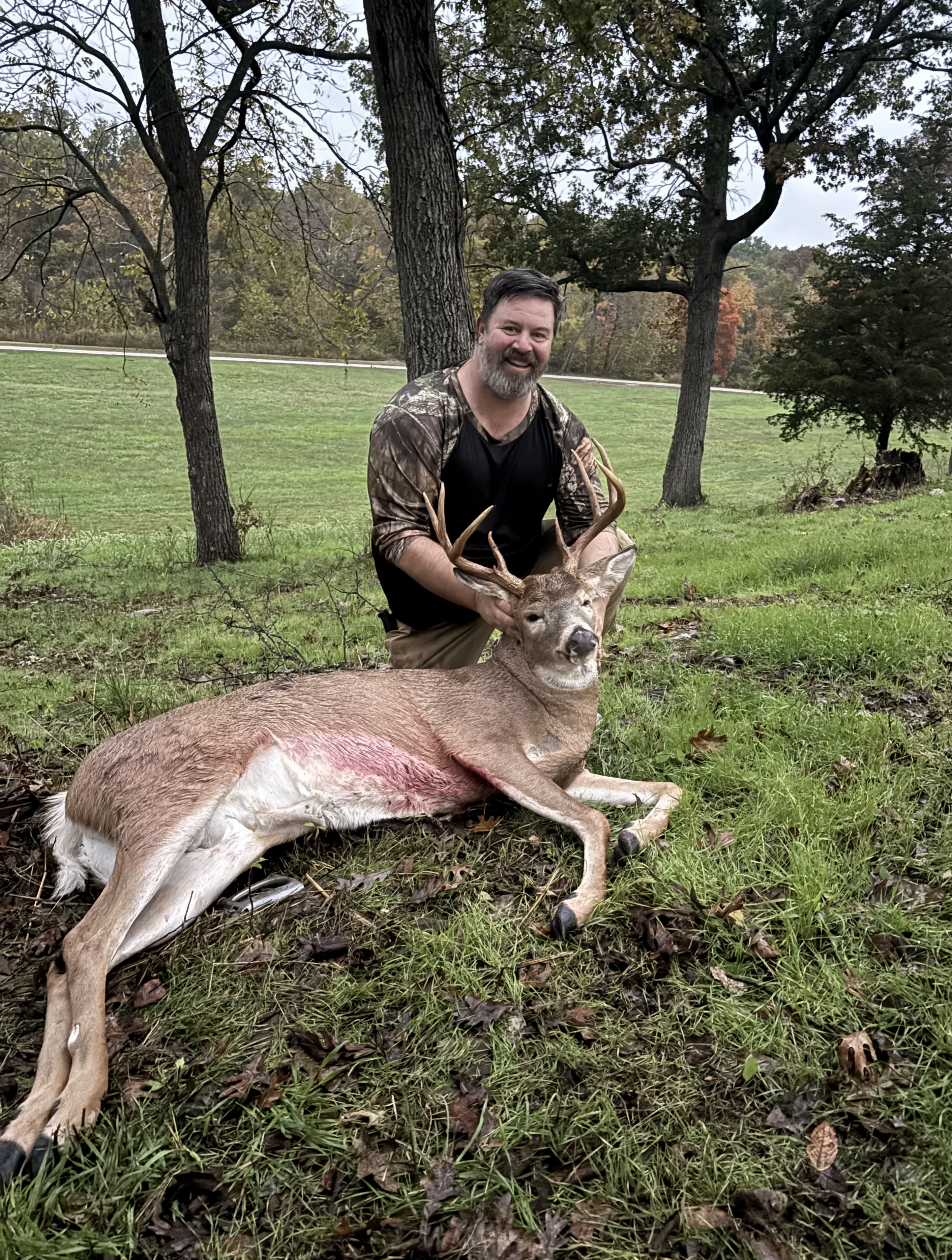 Hunter poses with buck deer after hunt, hunting in Missouri concept.