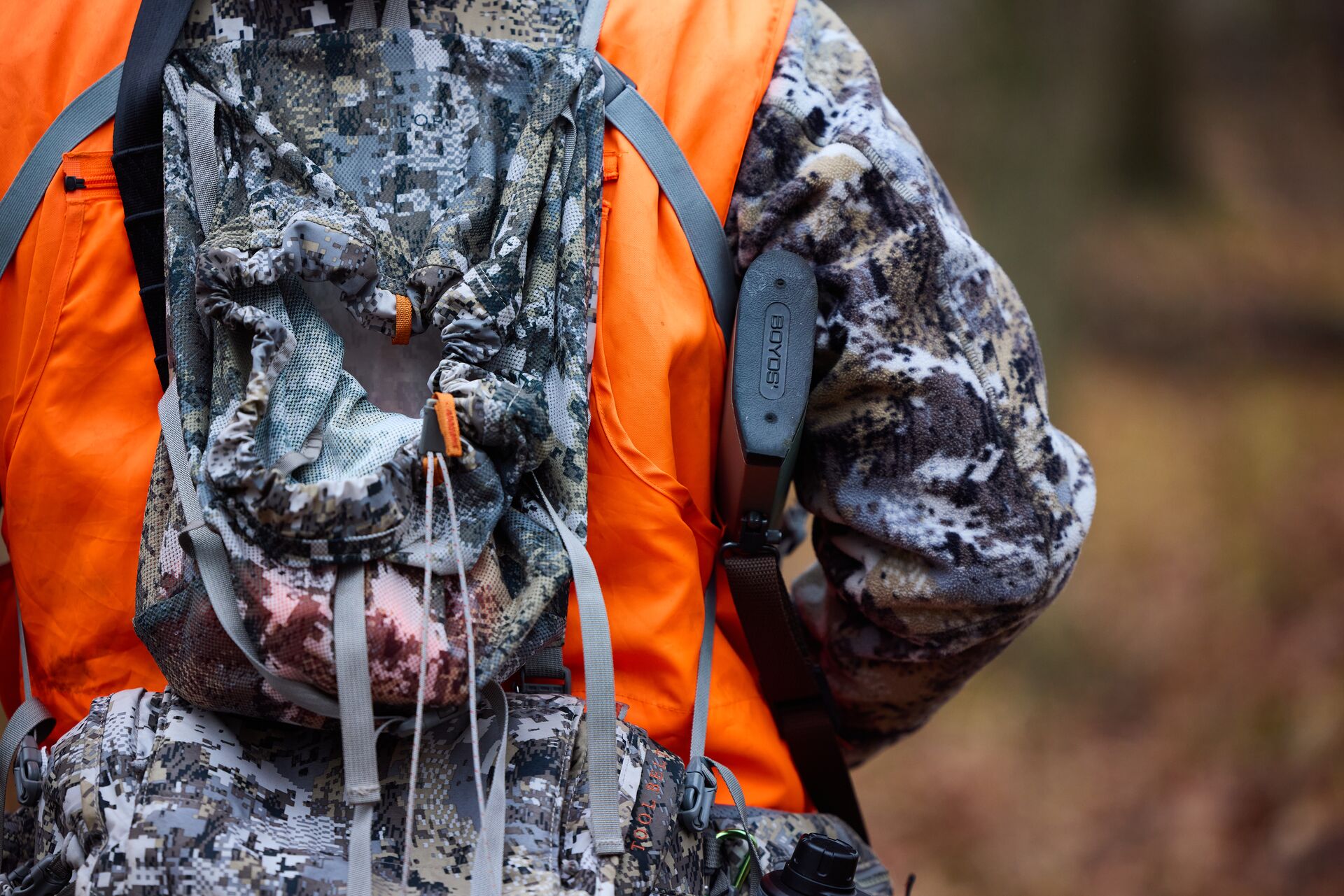 Hunter in blaze orange and camo, how to get a hunter safety course concept. 