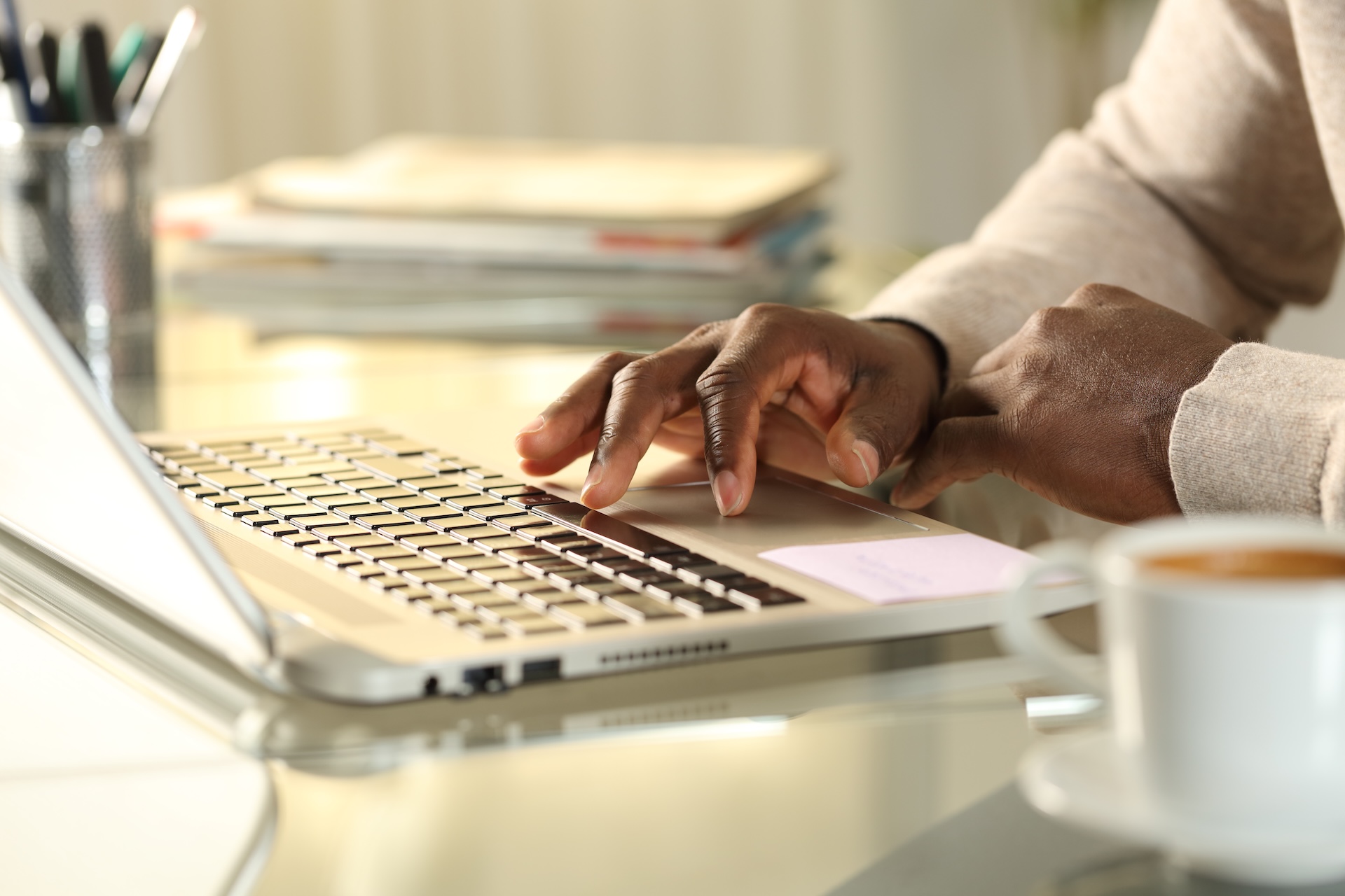 Close-up of hand on laptop keyboard, how to buy a hunting license online concept.