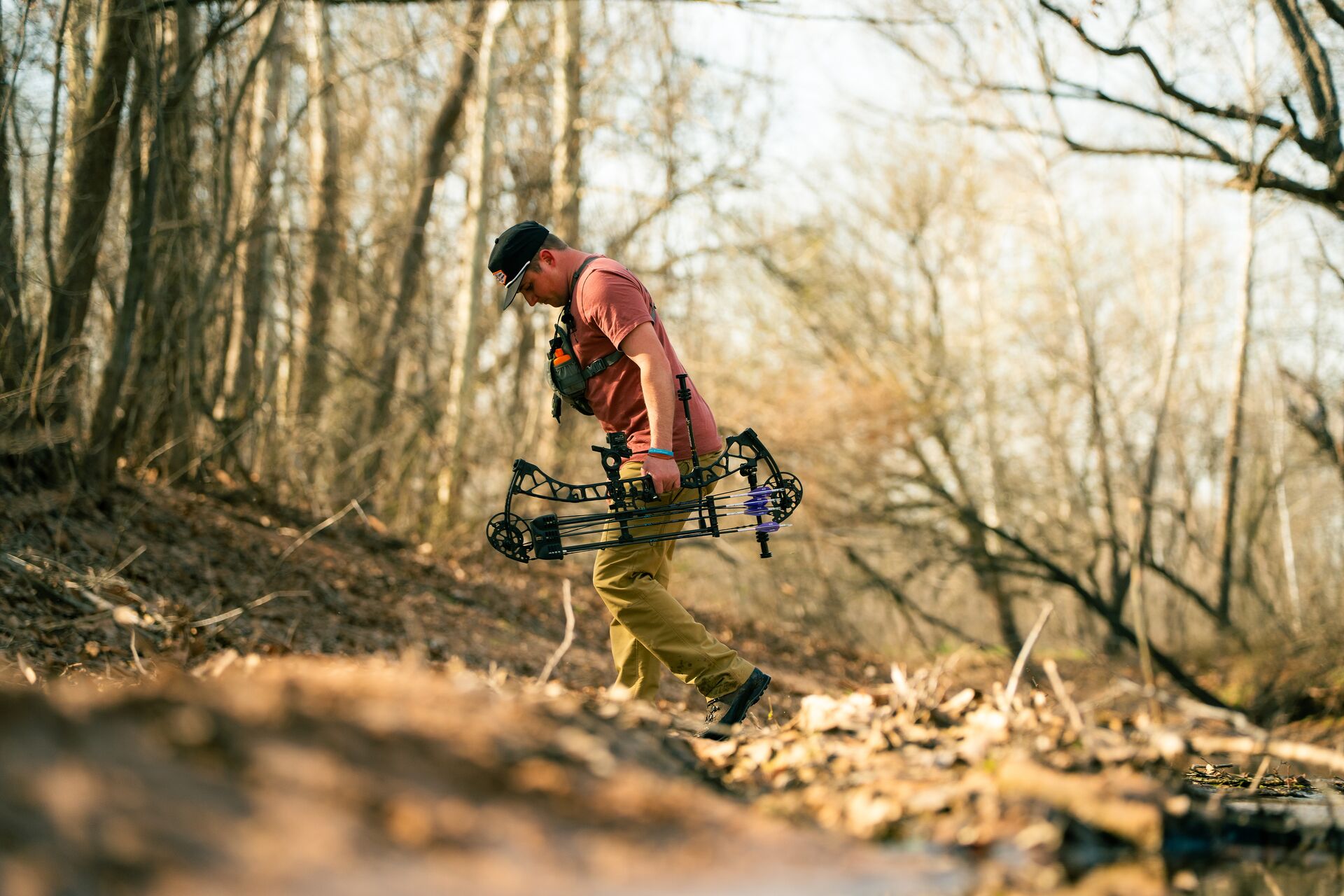 Hunter in the woods with a bow, take a hunter education course concept.