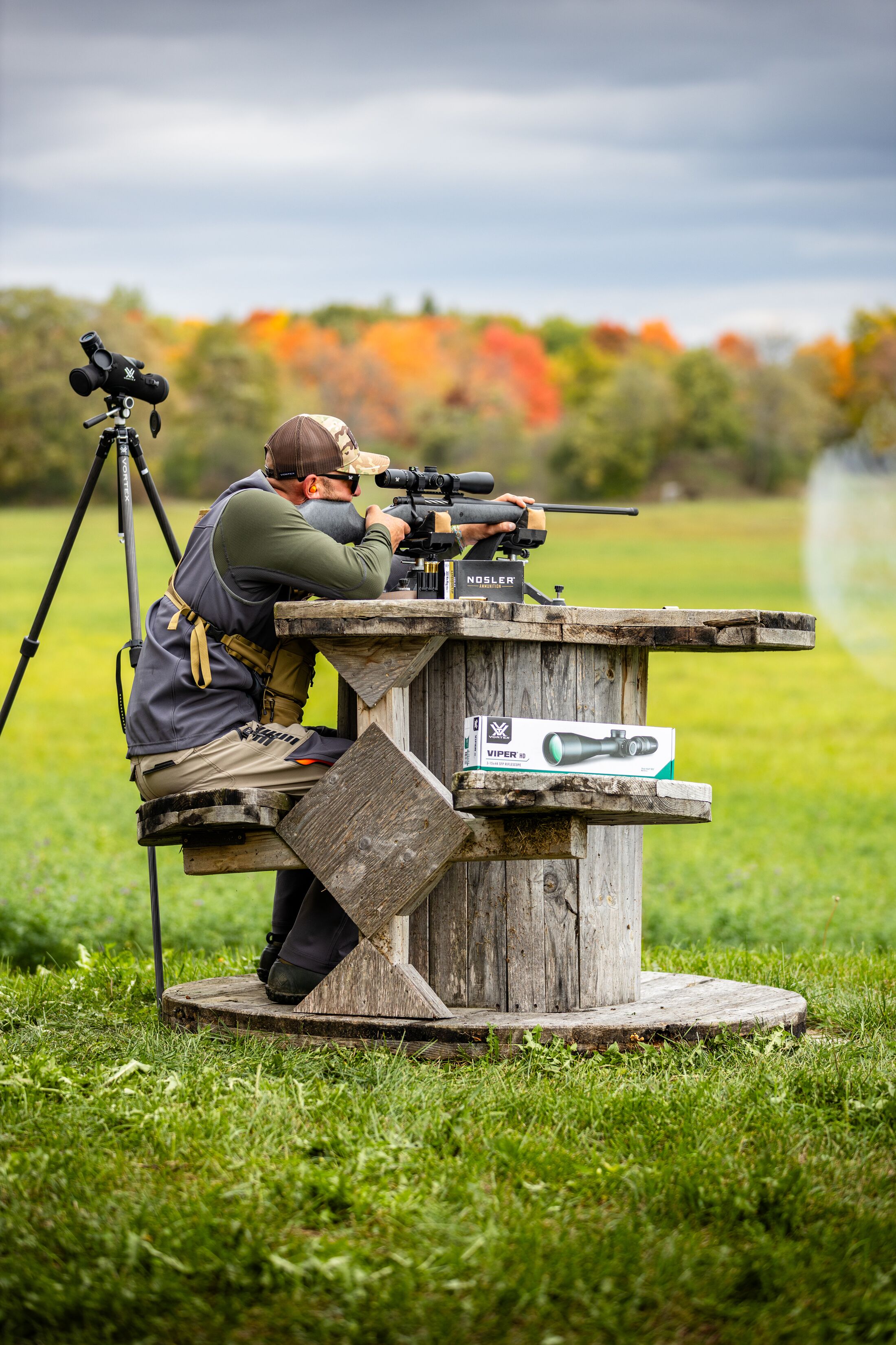 Hunter firing shotgun at the range, hunter education field day concept.