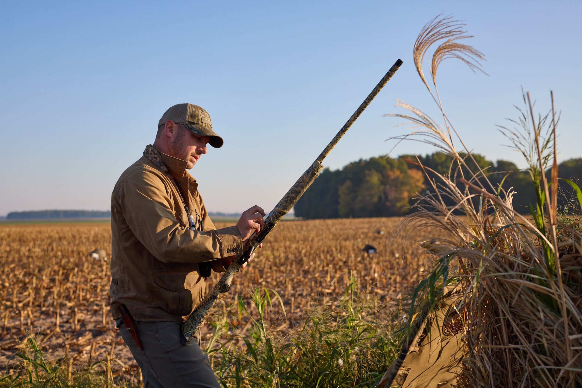 Hunter with shotgun in field, how to prepare for hunter education field day concept.