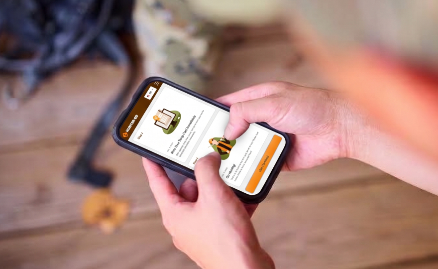 Phone screen showing Hunter-Ed course on screen, take hunter safety course online concept.