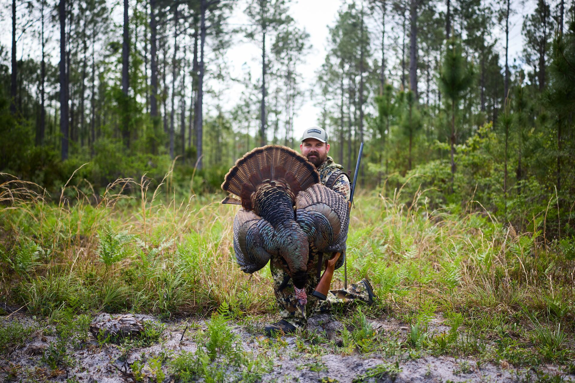 Hunter poses with turkey after hunt, turkey hunting safety concept. 
