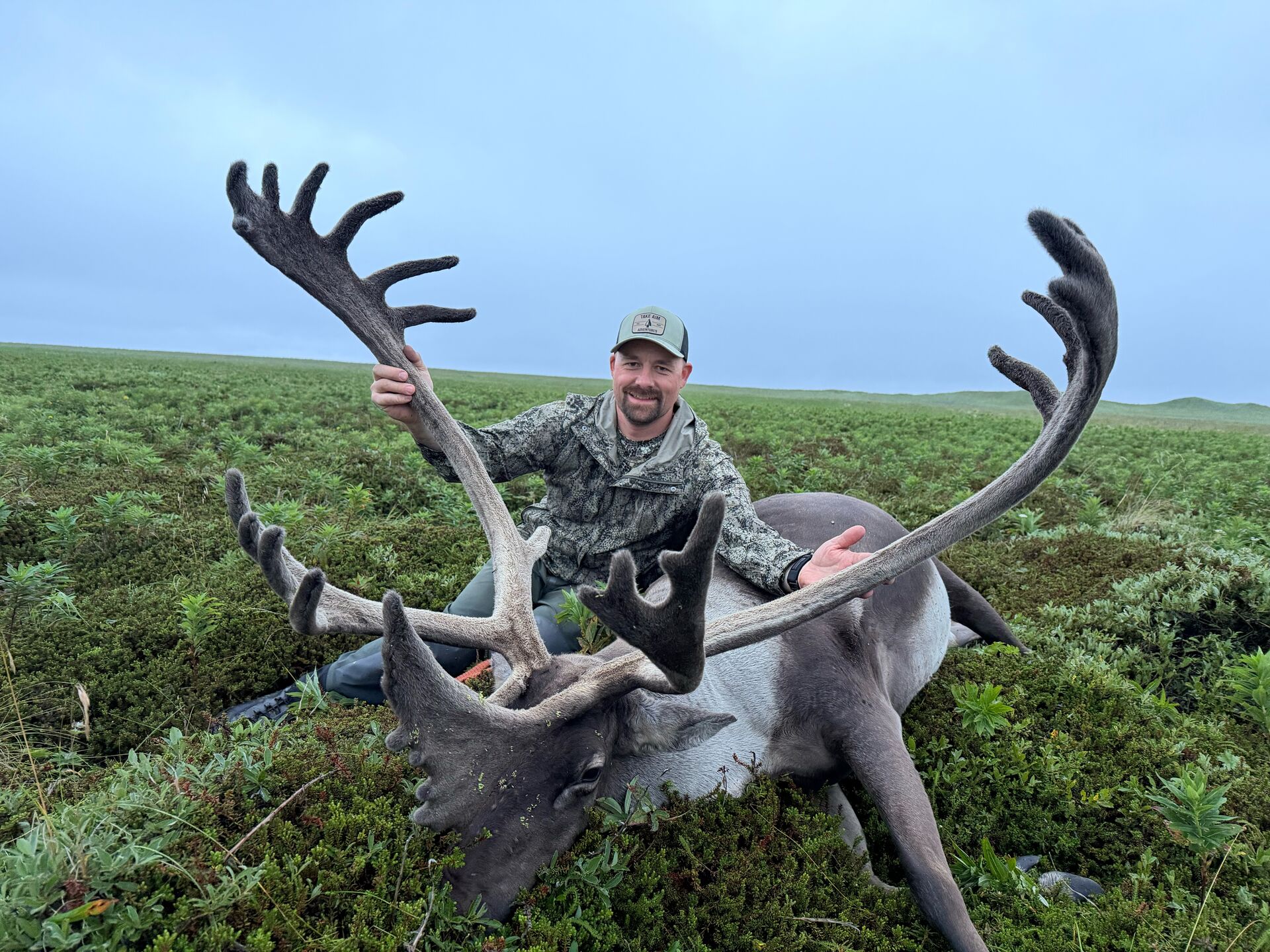 Hunter shows off moose and antler after hunt, is my hunting license valid in another state concept.